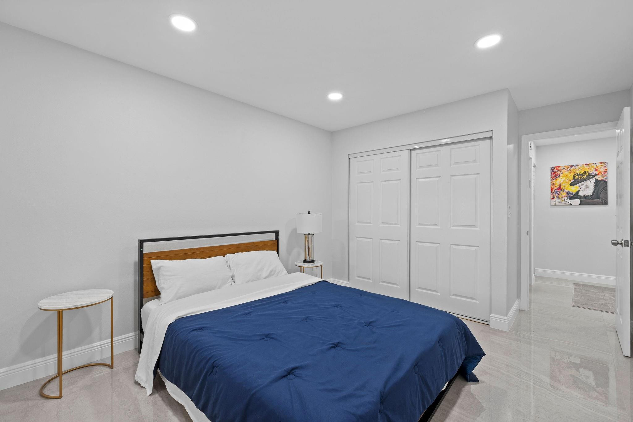 136 Greens Road Hollywood, FL 33021 - Photo 23 of 32 a bedroom with a bed and a painting