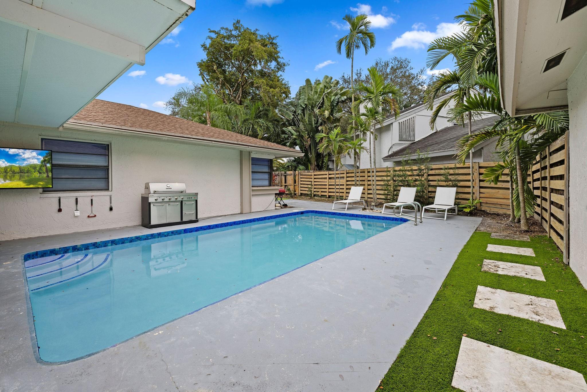 136 Greens Road Hollywood, FL 33021 - Photo 24 of 32 a view of swimming pool with a yard