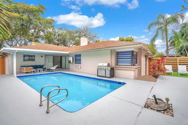 a view of a backyard with swimming pool