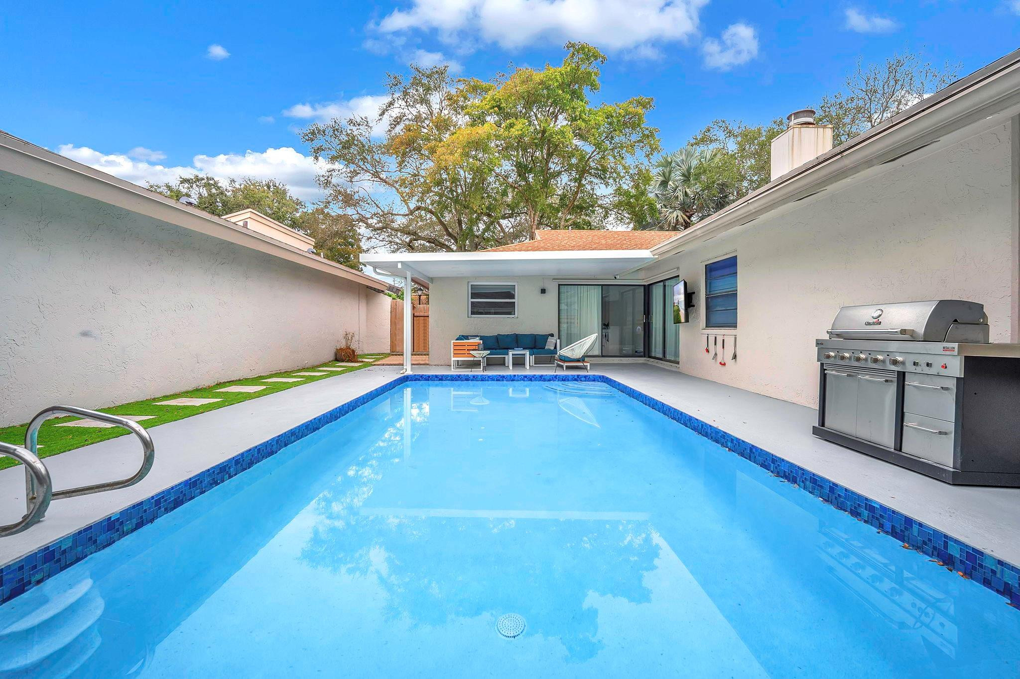 136 Greens Road Hollywood, FL 33021 - Photo 28 of 32 a view of a backyard with swimming pool