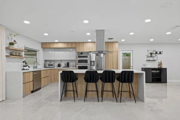 a large kitchen with a table and chairs in it