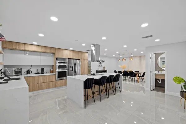 a large kitchen with a table and chairs