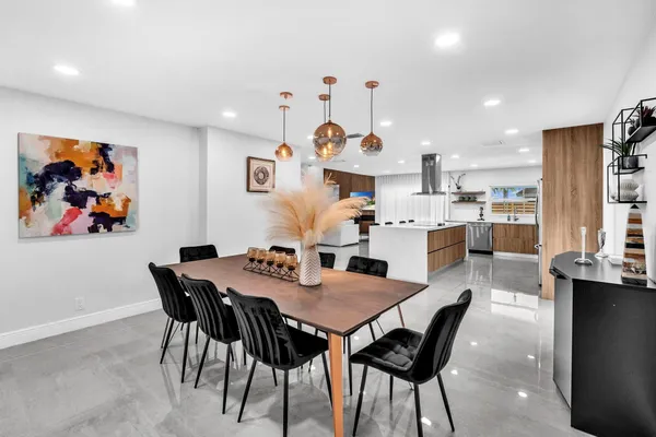 a view of a dining room with furniture and chandelier