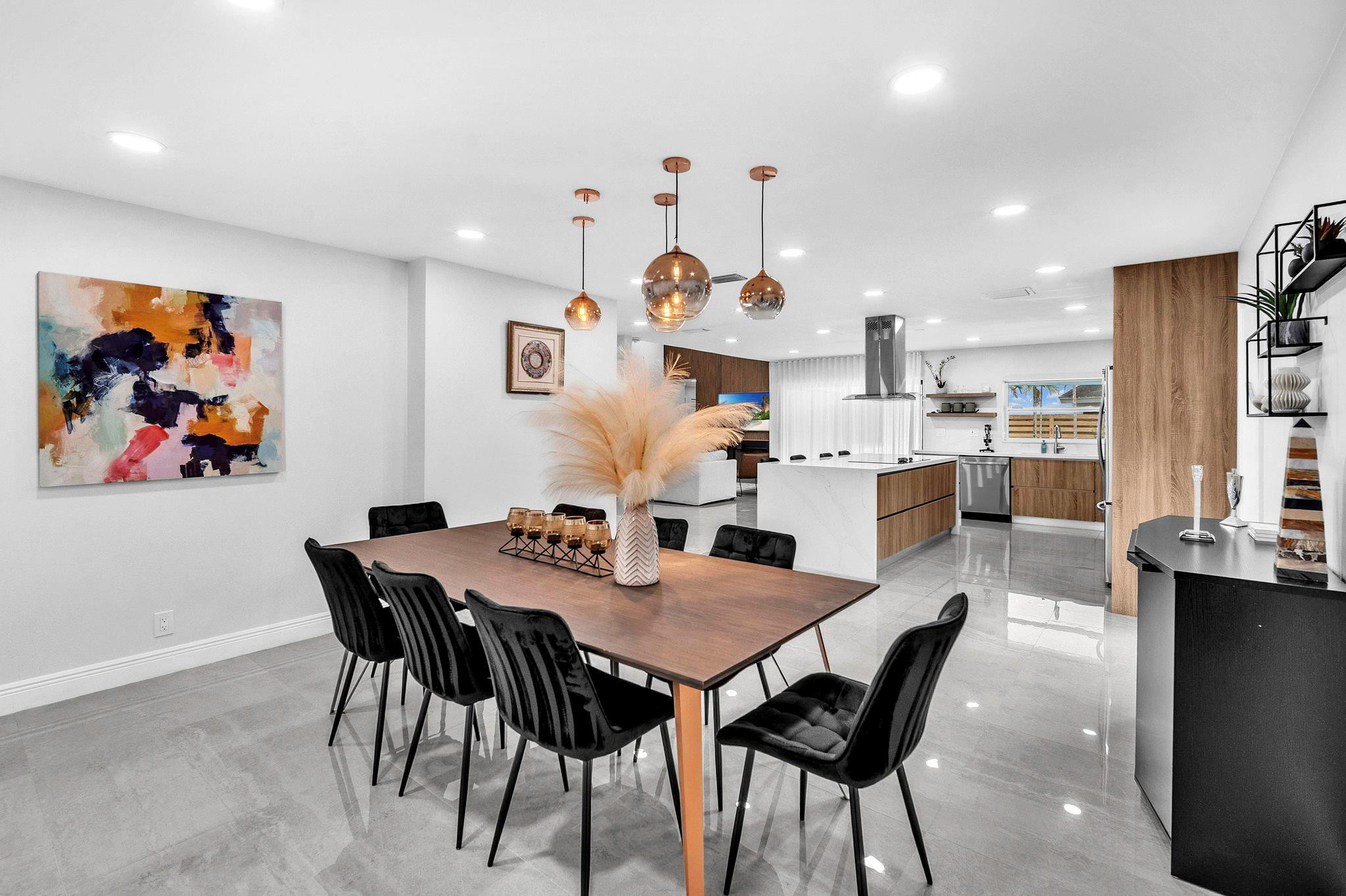 136 Greens Road Hollywood, FL 33021 - Photo 9 of 32 a view of a dining room with furniture and wooden floor