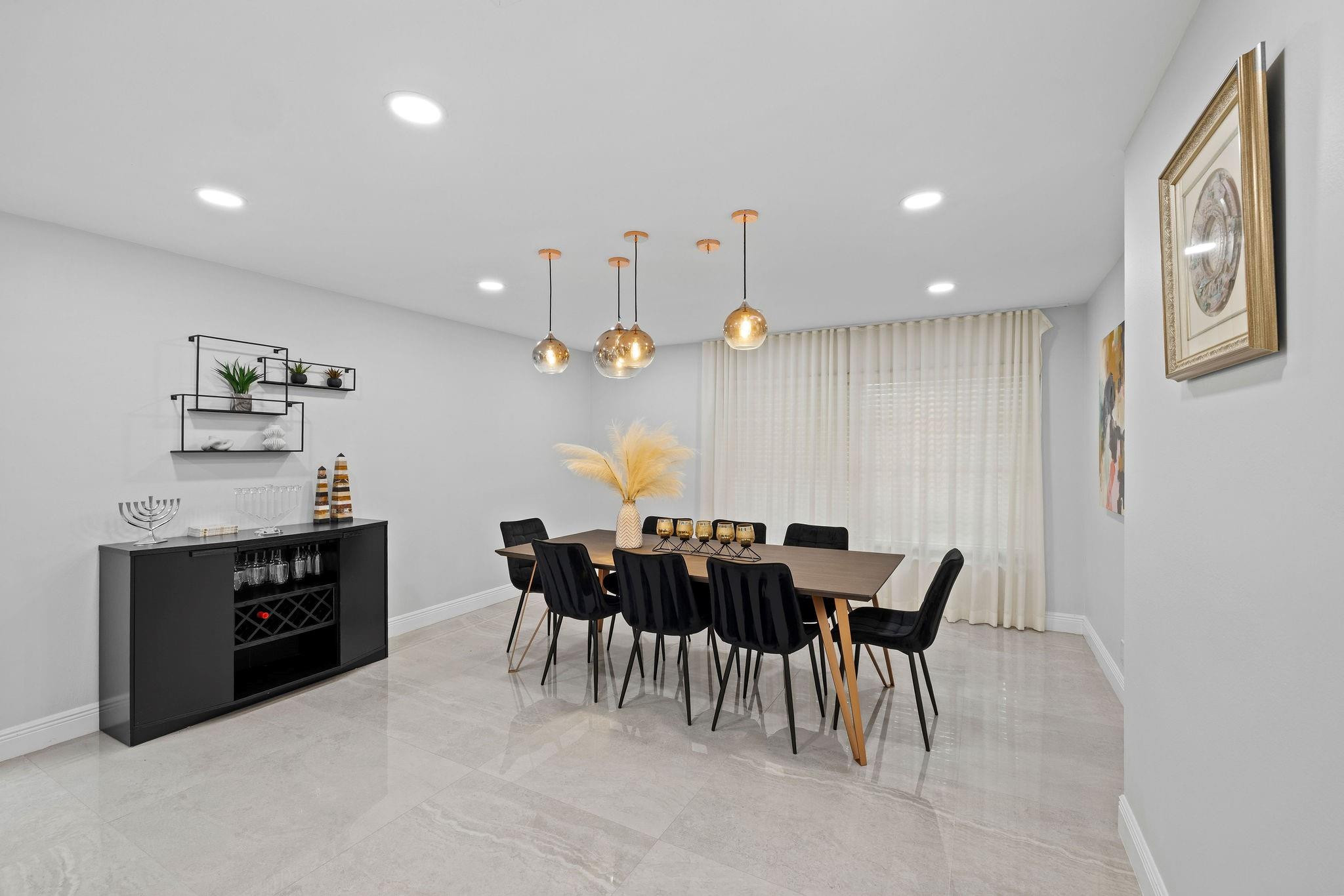136 Greens Road Hollywood, FL 33021 - Photo 10 of 32 a view of a dining room with furniture and chandelier