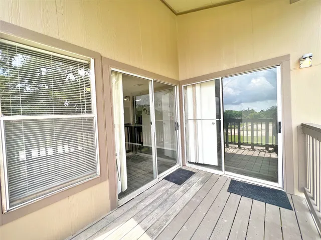a view of a room with wooden floor and balcony