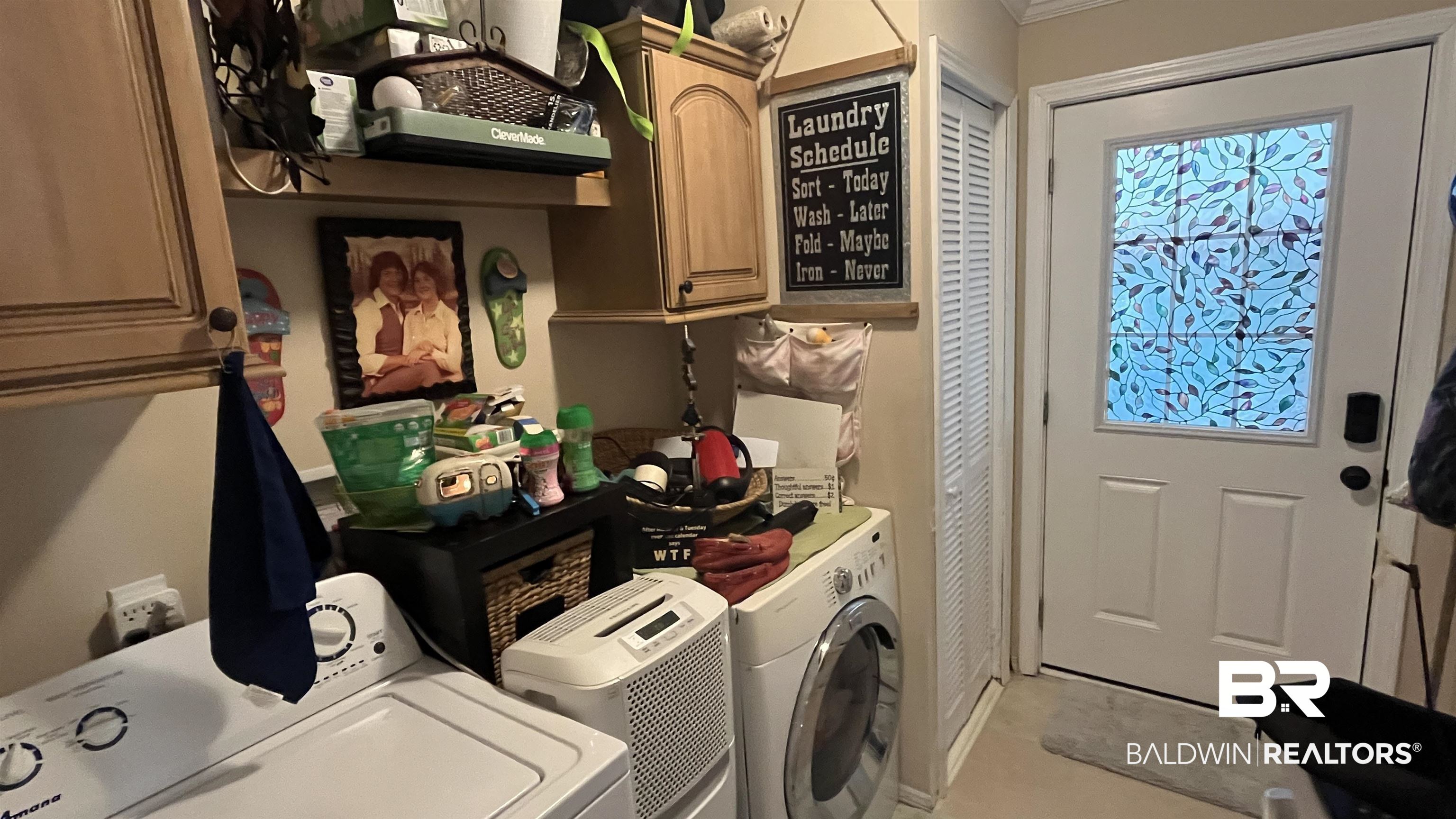 12932 Santa Piedro Street Lillian, AL 36549 - Photo 8 of 20 Washroom with cabinet space, washer and clothes dryer, and ornamental molding