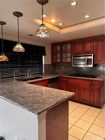 a kitchen with stainless steel appliances granite countertop a sink and a microwave