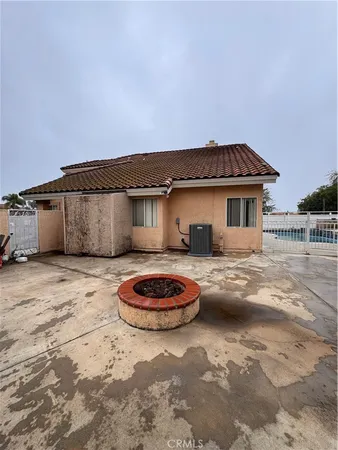 a view of a backyard with furniture and tub