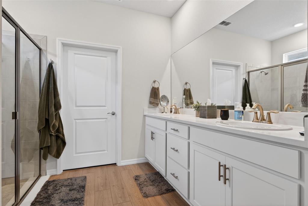 18237 Beach Ranch Terrace Bradenton, FL 34211 - Photo 44 of 72 a bathroom with a double vanity sink and mirror