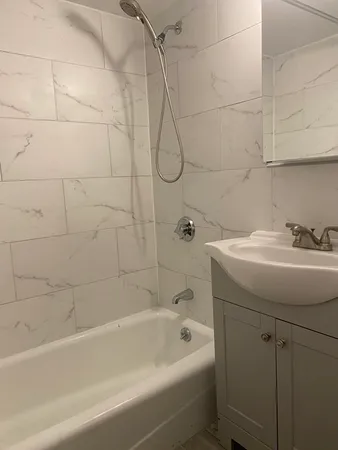 a bathroom with a sink a toilet and bathtub