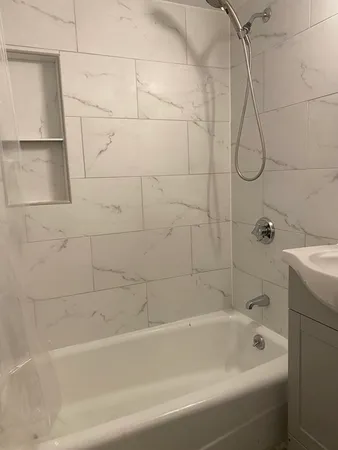 a bathroom with a bath tub with a shower