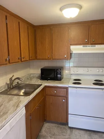 a kitchen with a sink stove and cabinets