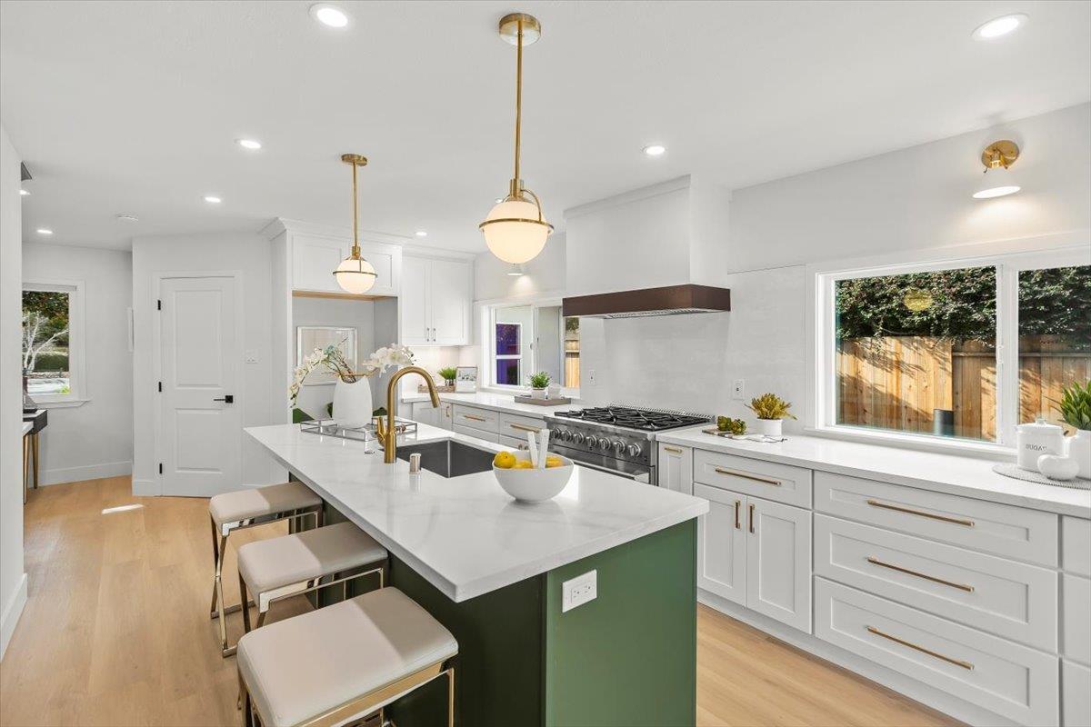 699 Cambrian Drive Campbell, CA 95008 - Photo 3 of 35 a kitchen with a sink a stove and chairs