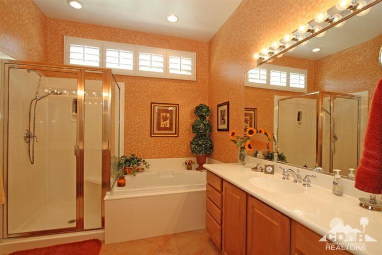 80563 Knightswood Road Indio, CA 92201 - Photo 23 of 33 a bathroom with a tub sink shower and mirror