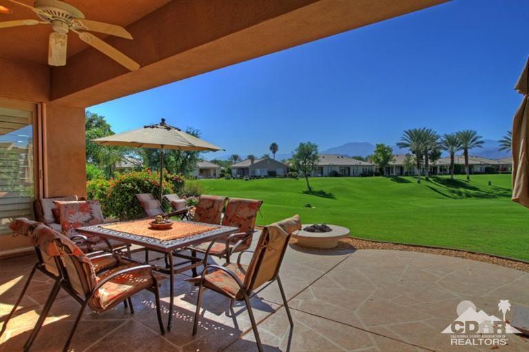 80563 Knightswood Road Indio, CA 92201 - Photo 28 of 33 a view of a patio with table and chairs under an umbrella