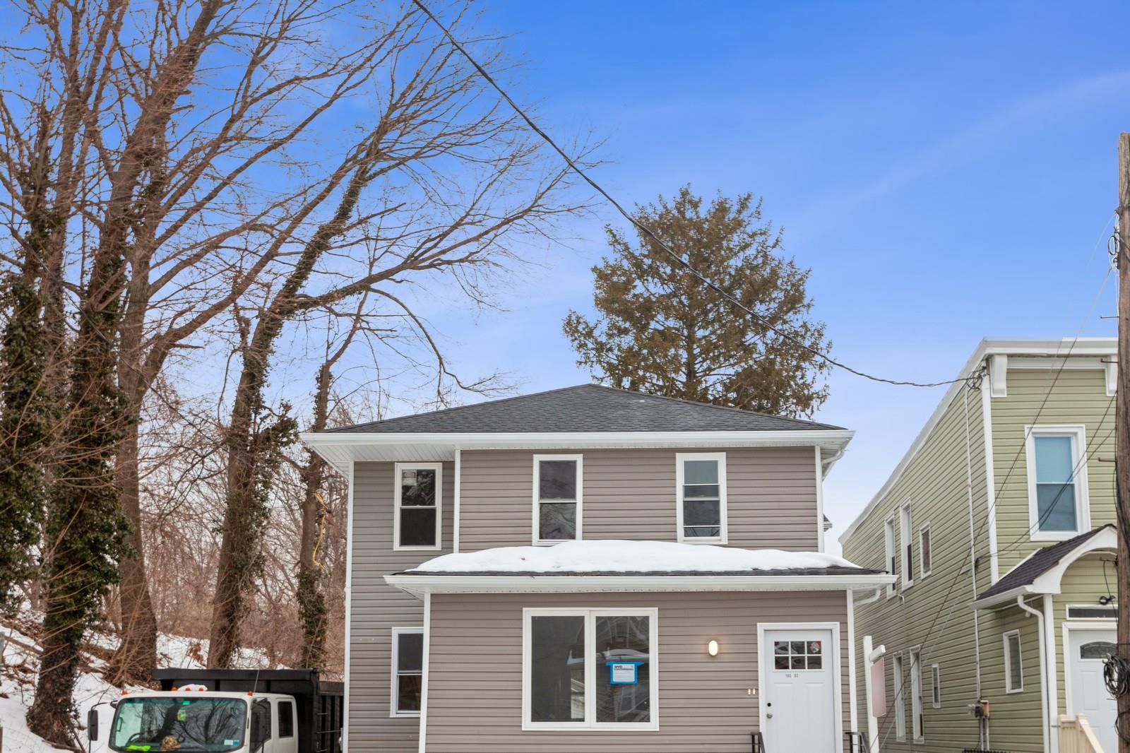 View of front of property featuring roof with shingles