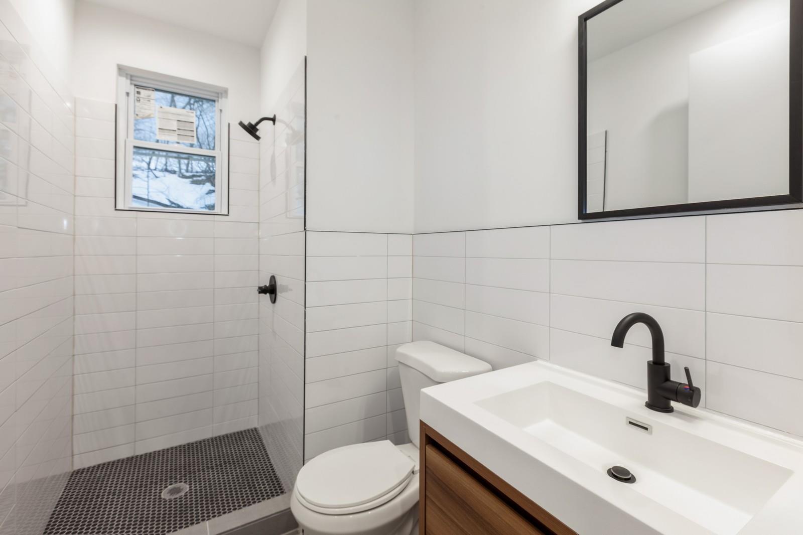 100-03 90th Avenue Queens, NY 11418 - Photo 3 of 18 Full bath featuring tile walls, vanity, toilet, and tiled shower