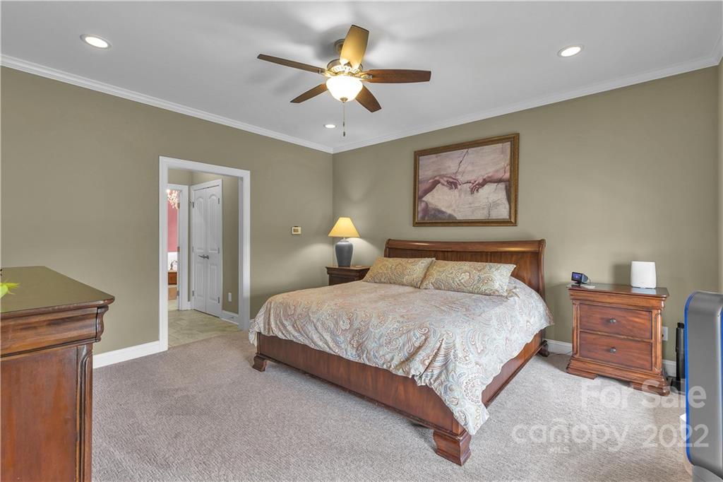 2510 South Potter Road Lancaster, SC 29720 - Photo 13 of 39 a bedroom with a bed and a chandelier