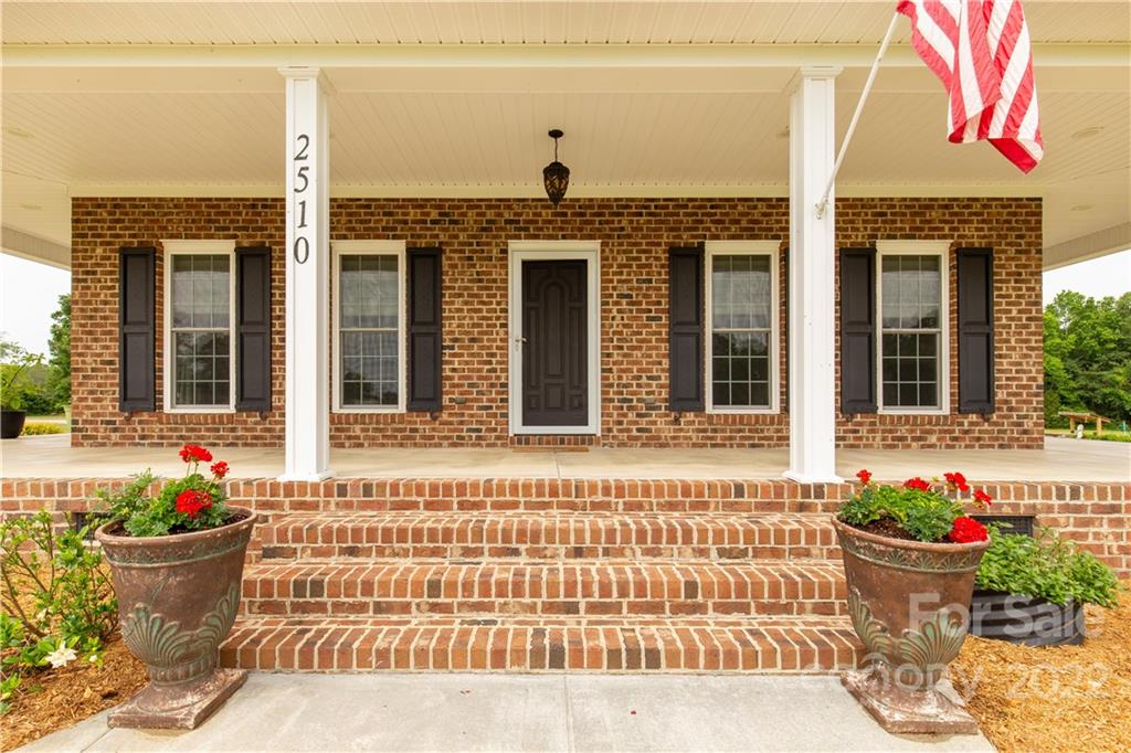 2510 South Potter Road Lancaster, SC 29720 - Photo 2 of 39 a front view of a house with potted plants