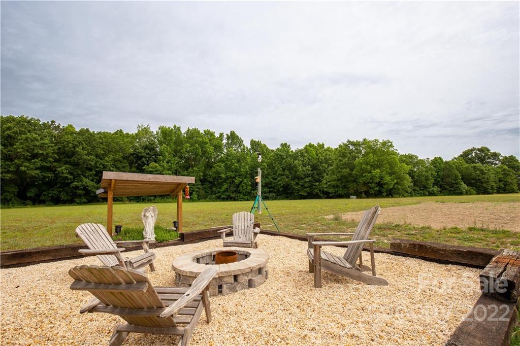 2510 South Potter Road Lancaster, SC 29720 - Photo 24 of 39 a view of swimming pool with lawn chairs wooden floor and fence