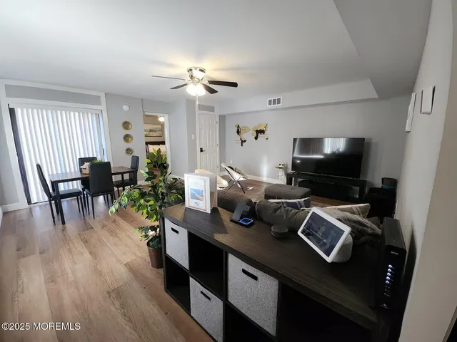a view of a workspace with furniture and wooden floor