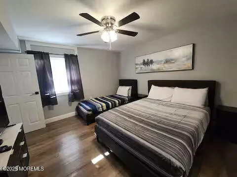 a bedroom with bed and wooden floor