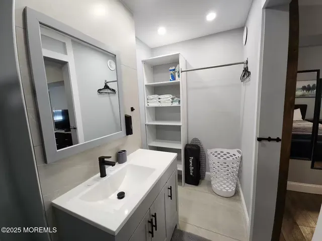 a bathroom with a sink and mirror