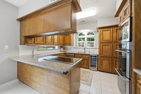a kitchen that has a sink cabinets counter space and stainless steel appliances