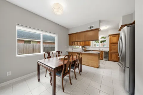 a kitchen with kitchen island a counter top space a sink stainless steel appliances and cabinets
