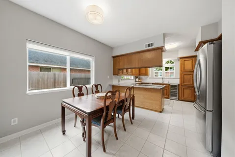 a kitchen with kitchen island a counter top space a sink stainless steel appliances and cabinets