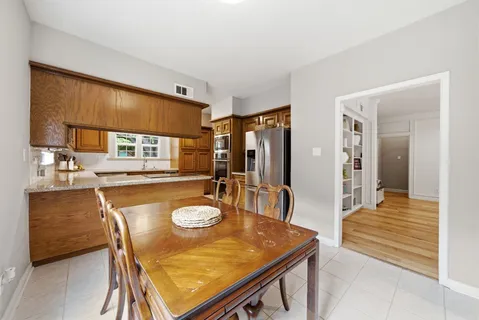 a dining room with furniture and wooden floor