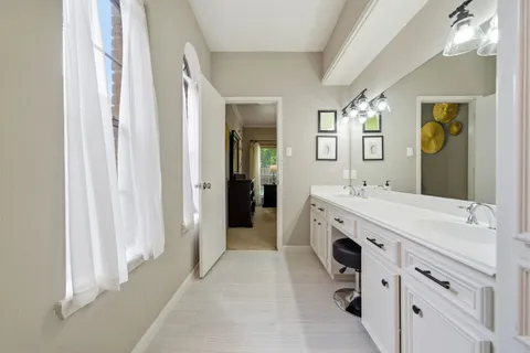 a bathroom with a double vanity sink mirror and