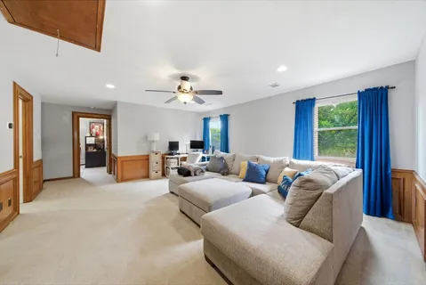 a living room with furniture and large windows