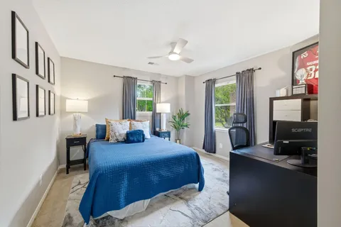 a bedroom with a bed a couch and dresser