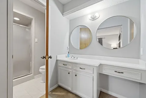 a spacious bathroom with a double vanity sink and a mirror