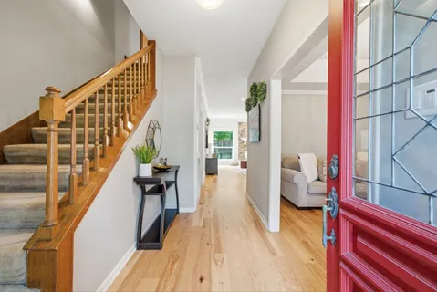 a view of entryway and hall with wooden floor