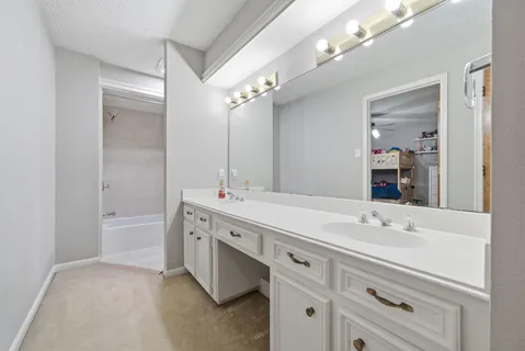 a bathroom with a sink double vanity and a mirror