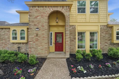 a front view of a house with plants