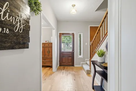 a view of an entryway with wooden floor