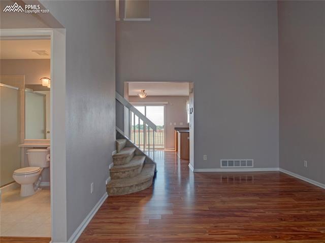 7680 Tompkins Road Peyton, CO 80831 - Photo 4 of 30 Enter into the living room. See through to the kitchen/dining area. Notice the main-level 3/4 bath