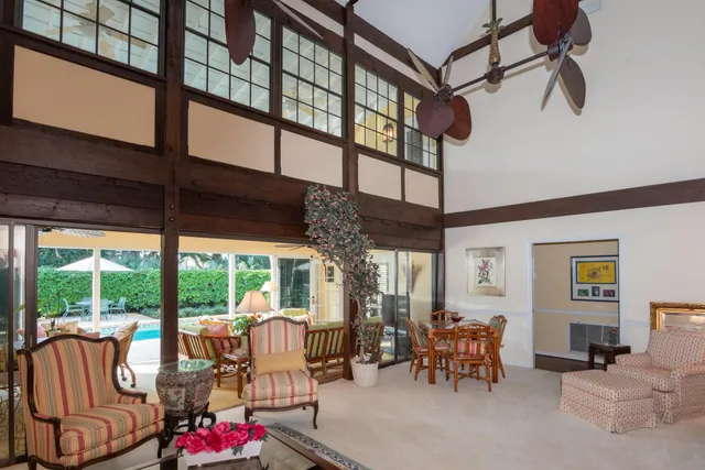 a living room with furniture and large window