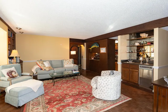 a spacious bedroom with a bed and dresser