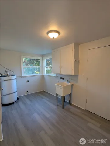 a view of a room with wooden floor and window