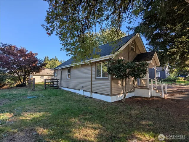 a view of the house with a yard