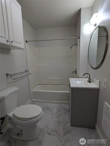 a bathroom with a sink mirror vanity and toilet