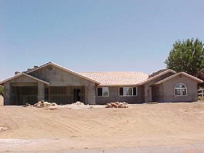 12425 Reata Road Apple Valley, CA 92308 - Photo 1 of 1 a front view of a house with a yard
