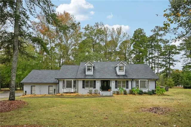 a front view of a house with a garden