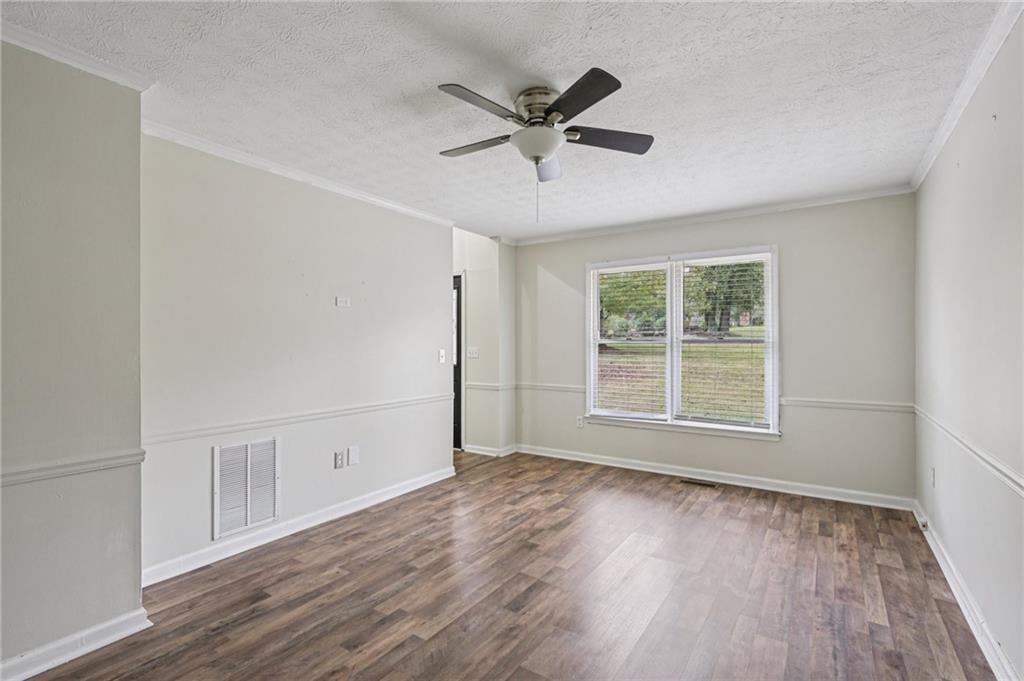 7379 North Mitchell Court Villa Rica, GA 30180 - Photo 20 of 82 a view of an empty room with wooden floor and a window