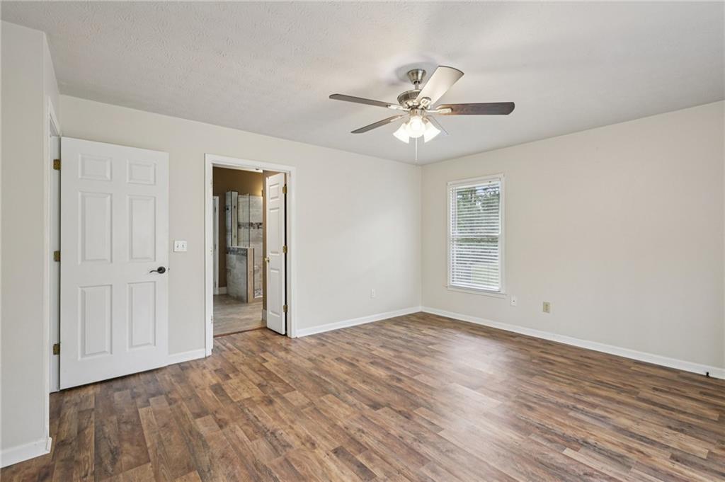 7379 North Mitchell Court Villa Rica, GA 30180 - Photo 31 of 82 a view of an empty room with wooden floor and a window